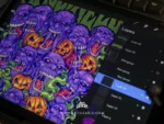 The halloweed ghoul artwork on a tablet showing digital layers with a keyboard behind it.