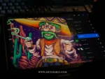 The cowboy bandit artwork on a tablet showing digital layers with a keyboard behind it.