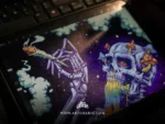 The trippy skull artwork on a tablet screen with the layers panel open, showing the digital process.
