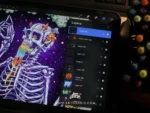 The trippy skeleton artwork displayed on a digital tablet screen, showing the artwork process.